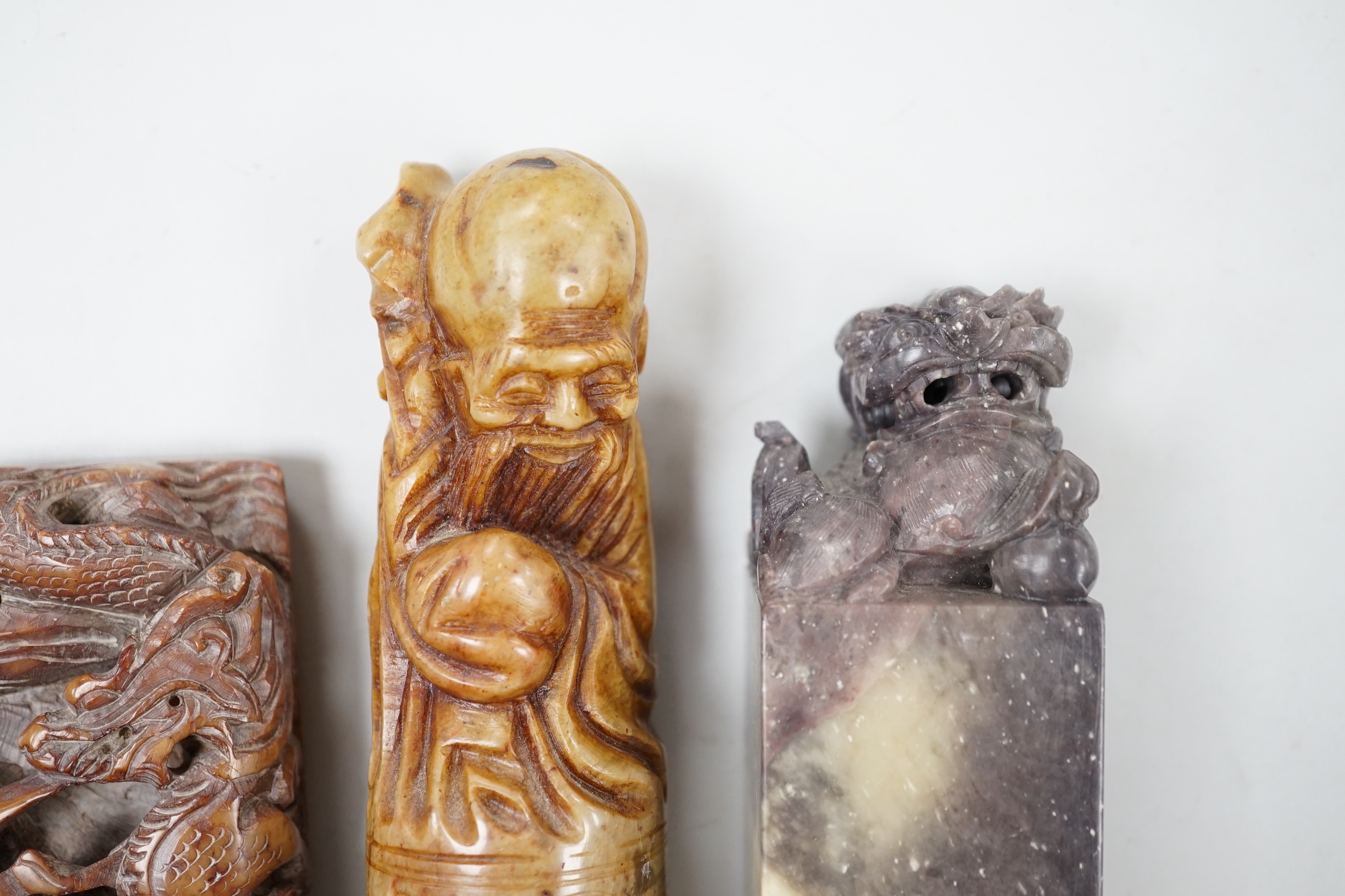 Three Chinese soapstone seals, tallest 12cm high